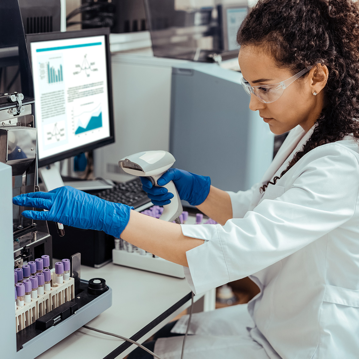 Laboratory specialist using digital diagnostic equipment